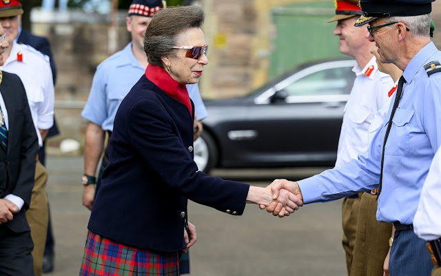 Princess Anne wore a red tartan skirt and navy black jacket. Gold earrings