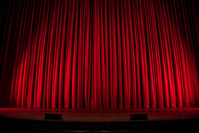 Red Curtain | Photo by Rob Laughter via Unsplash