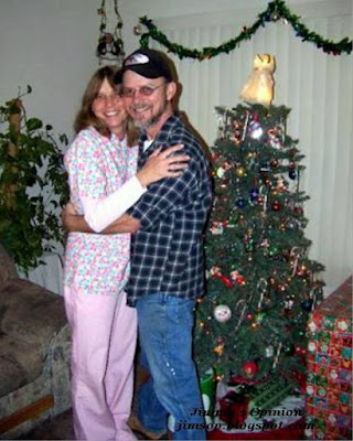 My wife Cindy and I standing in front of our Christmas tree many years ago