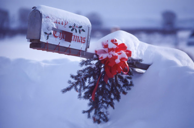 American style mailbox sticking out of the snow with Merry Christmas written on the side