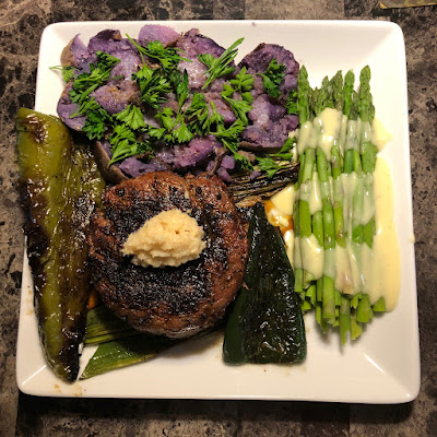 Rare grilled prime ribcap, with grilled leeks and peppers, smashed purple potatoes with parsley (aka Joker potatoes) and asparagus with Hollandaise