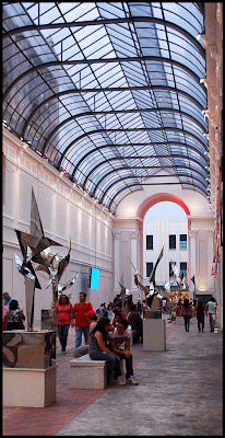 Merida Mexico's Museum of Contemporary Art Atrium entry with visitors and glass ceiling 