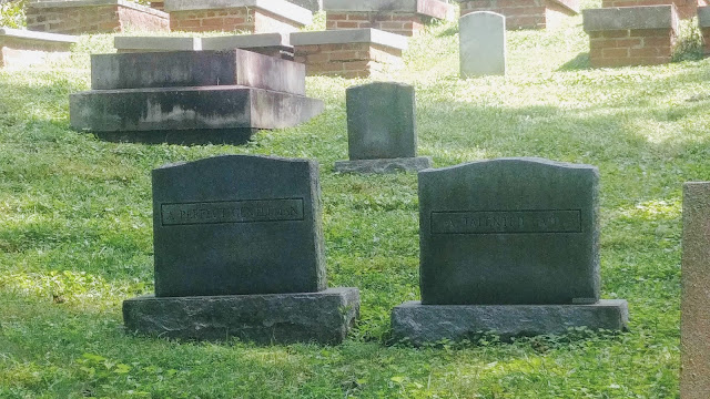 Two gravestones read "A perfect gentleman" and "A talented lady"