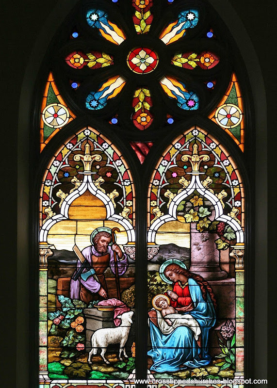 Large stained glass window of the Holy Family, Joseph, Mary and the infant Jesus