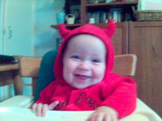 Baby wearing Halloween Costume featuring Devil Horns