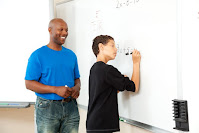 Teacher and student at white board