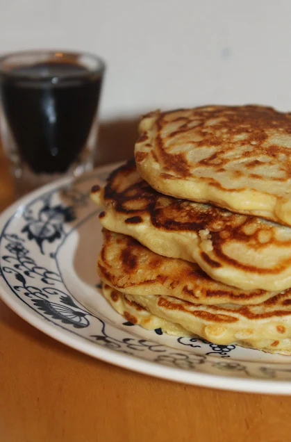 Stack of oatmeal pancakes on a serving plate.