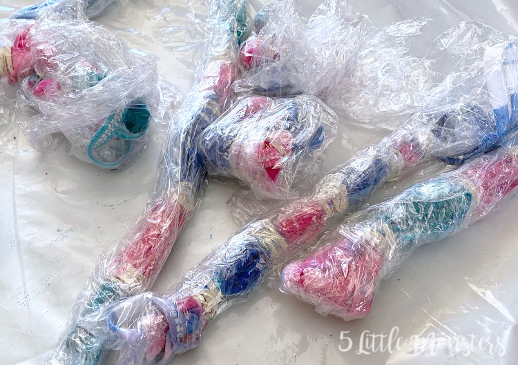 tie dyed masks wrapped in plastic wrap