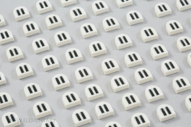 1x1 half circle tiles in white with a printed decorative double arch window design