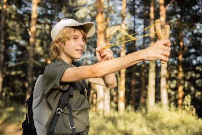 picture of a boys scout in uniform with a heavy backpack