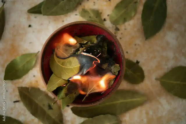 Burning dried bay leaves in a small dish for cleansing ritual