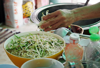 Adding veggies and beansprouts