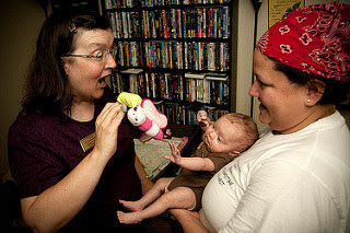 Image: Cpl. Gretch Sweeney and Elaine Sexton play with baby Emily- FMWRC - US Army - 100813, by U.S. Army on Flickr