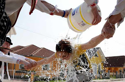 Men in traditional Slovak clothes throw buckets of cold water on women in a Selec village 120 km east of Bratislava 