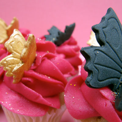 Fuschia cupcakes with gold and black butterflies