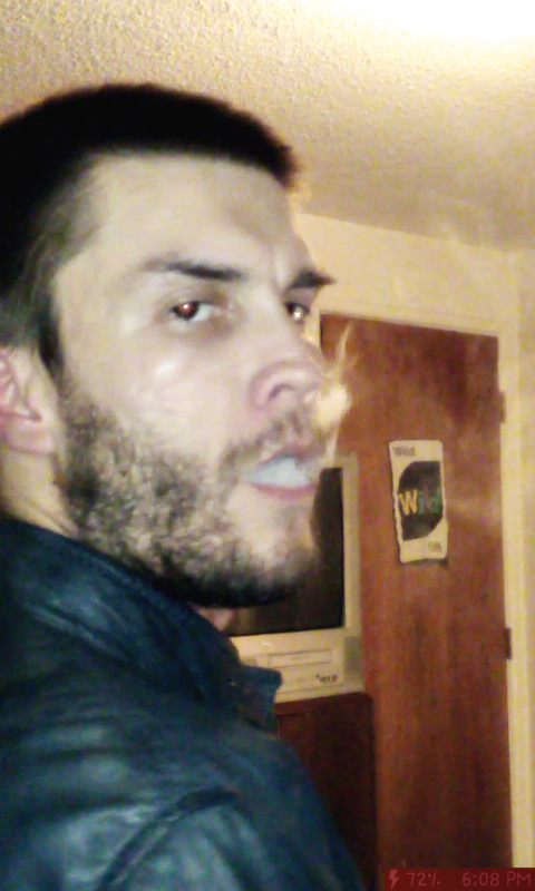 Oregonleatherboy bearded blowing thick cigar smoke in blue Versace leather jacket