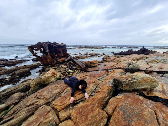 woman poses with Cape Town shipwreck