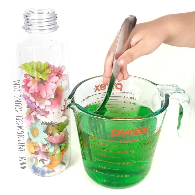 stirring food colouring for sensory bottle