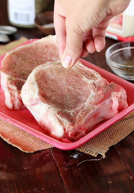 Seasoning Pork Chops with Salt and Pepper Image