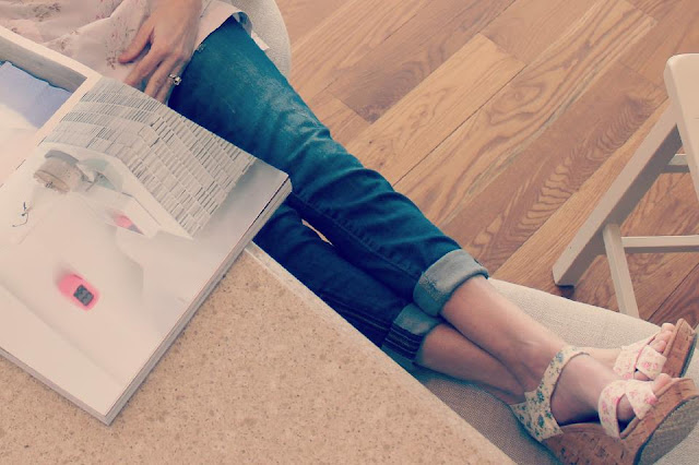 Image of woman in jeans with feet up relaxing in beautiful French Country kitchen - blogger Michele of Hello Lovely Studio