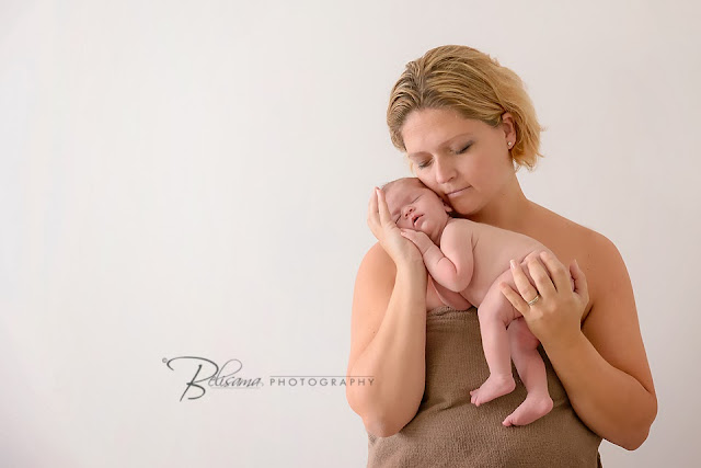 cute newborn baby sleeping in mother's arms