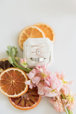 wedding rings with dried oranges in white ring box