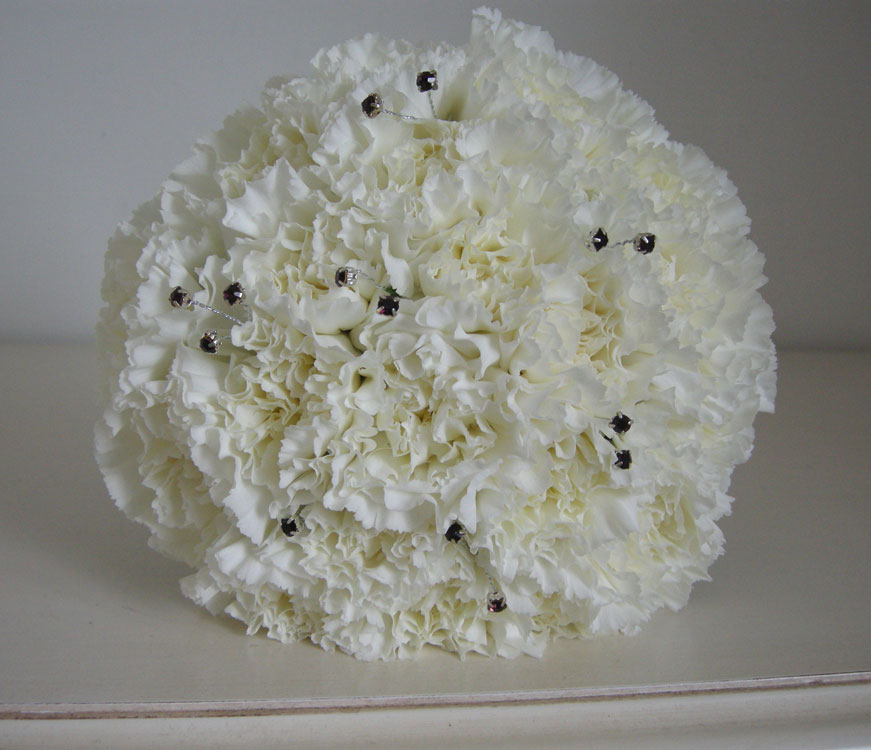 Ivory and purple bridesmaid's bouquet of massed carnations the detail shot