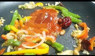 stir frying vegetables with sauces for dragon chicken