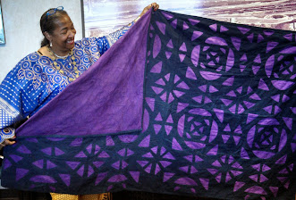 Teresa R.Kemp showing Wall hanging from Nigeria Africa with Sonya Hodges at the Cornbread Festival in Columbia SC.