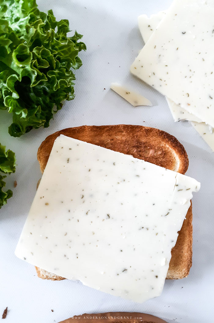 Bread with slice of green onion cheese on top