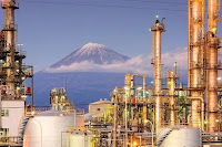 Oil and Gas Accounting- A view of an oil refinery with a mountain at the background