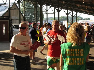 Phil Smith and Gary Davis hand out fans at the Harrison County Fair