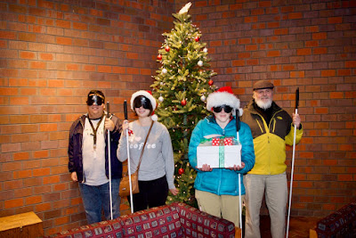 Dan Burke and Colorado Center for the Blind students Cristian, Shyanne, Kelly,  beside the Christmas Tree while delivering treat to City of Littleton offices