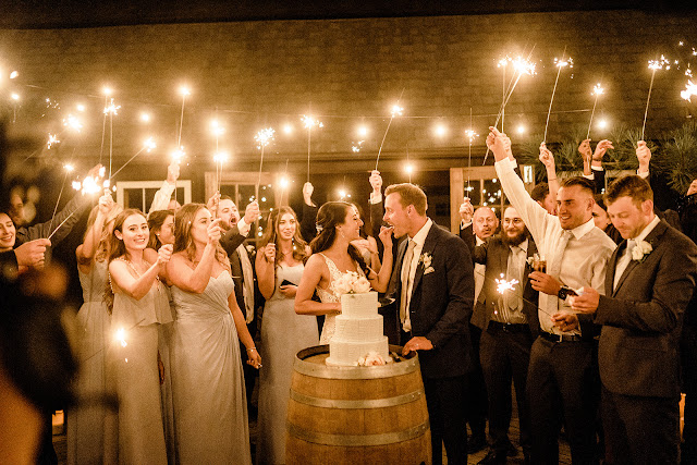 Niagara Wedding Planner | A Divine Affair | Sara and Daniel - Photo by Julia Park Photography. Ceremony and Reception at Kurtz Orchards Gracewood Estates. Ceremony under a chiffon and floral draped tree. Reception in a tent with live edge wooden harvest tables. 