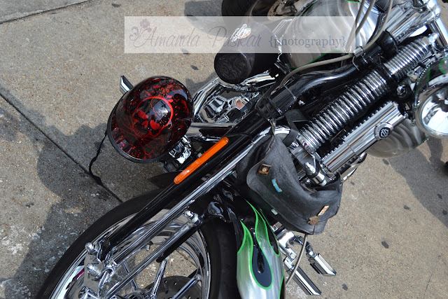 A contrast of color of red skull on helmet and green flames on bike