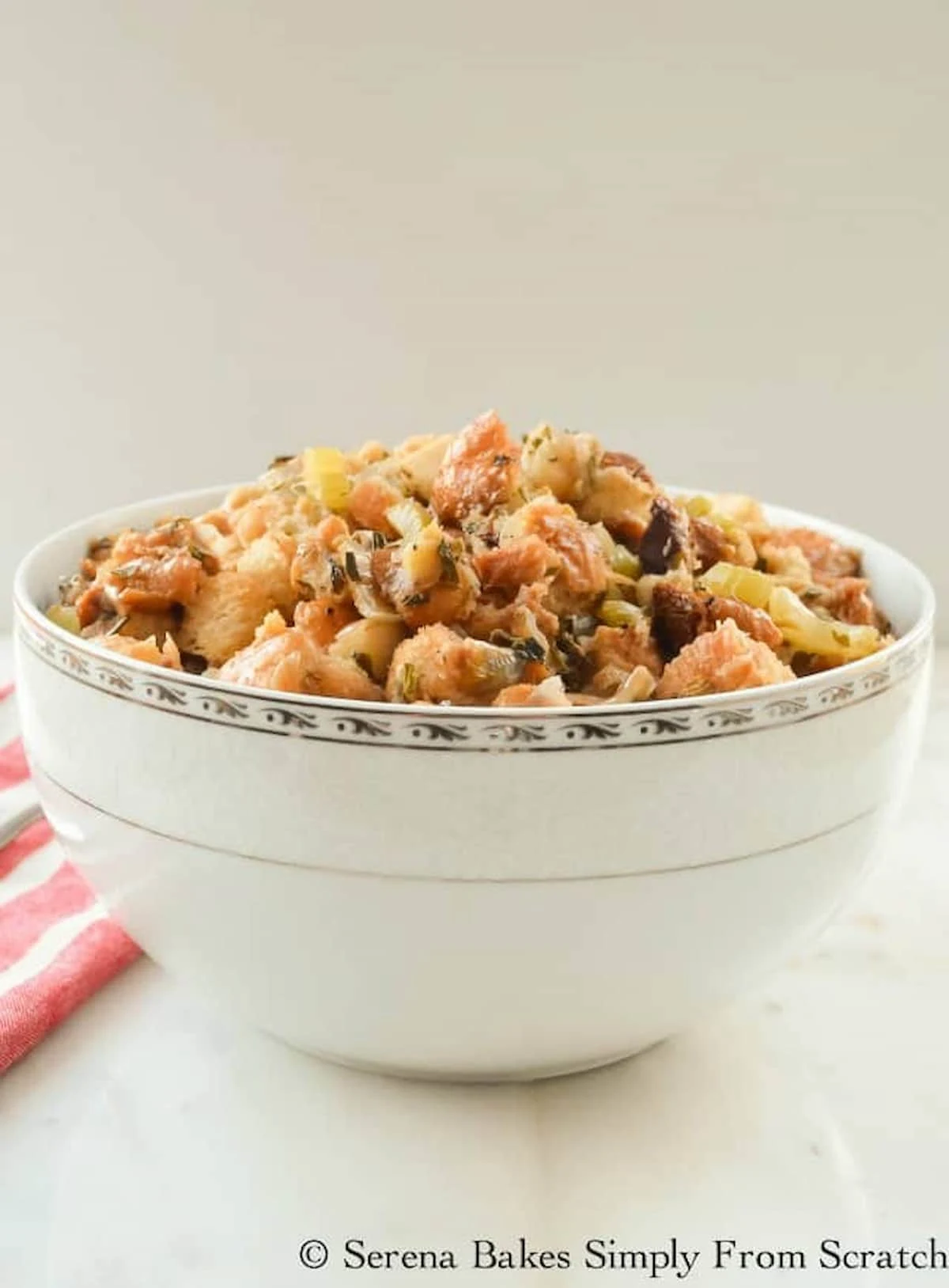 A side shot of Crock Pot Stuffing in a white bowl.