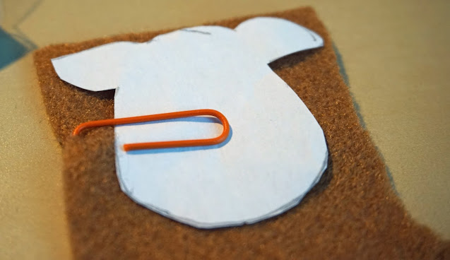 The Reindeer Template attached to the brown felt, with a orange paper clip