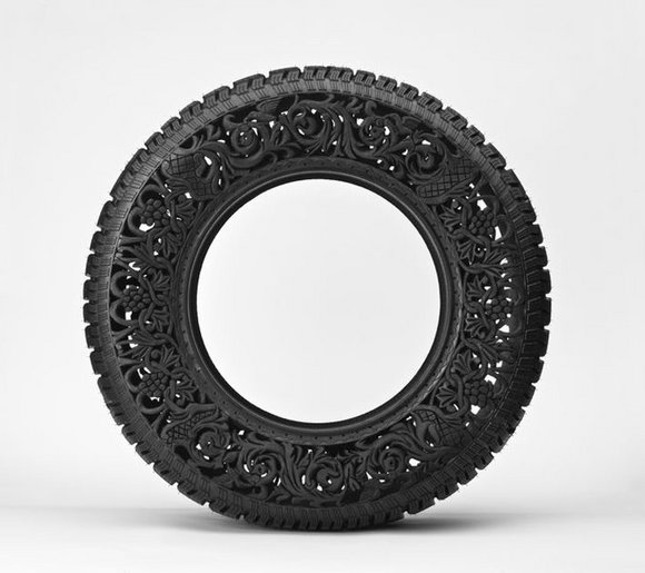  by handcarving intricate patterns and floral motifs on used car tires