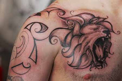 tribal lion tattoo on biceps