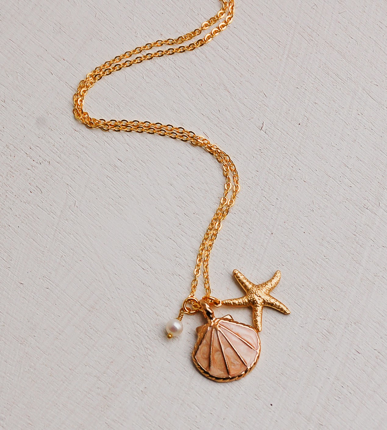 https://www.etsy.com/listing/223991572/sea-shell-necklace-gold-shell-necklace?ref=shop_home_active_1&ga_search_query=shell