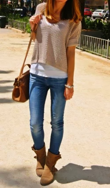 Grey sweater with brown hand bag and denim pants with long boots