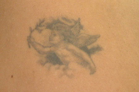 tattoo on her left shoulder a small angel holding a olive branch