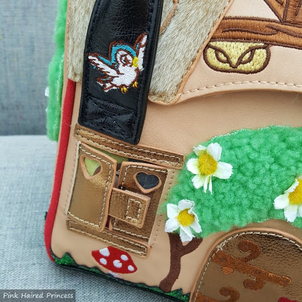 bird embroidery on handle and window detail on front of handbag