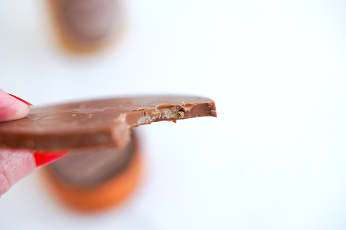 Milk Chocolate Rondos with Caramelized Pecan Crunch, piece with bite