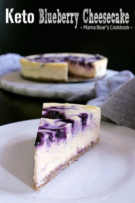 Bring on dessert heaven with this incredibly delicious Keto Blueberry Cheesecake, featuring an almond crust, low carb vanilla cheesecake and a blueberry lemon swirl. It's the ultimate low carb dessert! #lowcarb #keto #cheesecake #dessert #mamabearscookbook