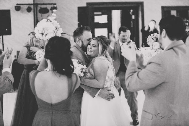 bride and groom hugging at  italian american cultural center in clinton township