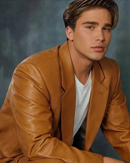 Handsome young blonde dude wearing an orange leather blazer