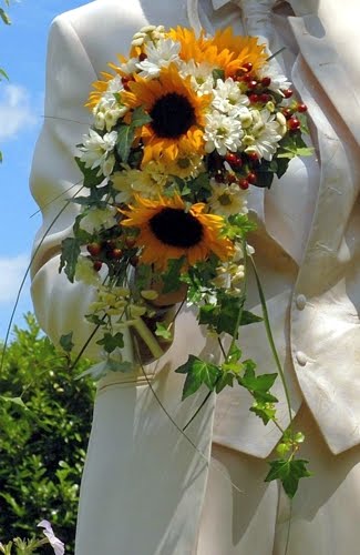 Sunflowers white flowers red berries and ivy leaves bridal bouquet
