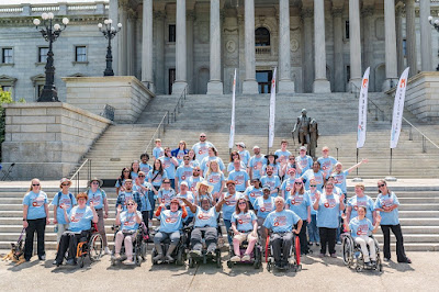 Large group of Advocacy Day for Access and Independence participants from previous event posed in front of State House image