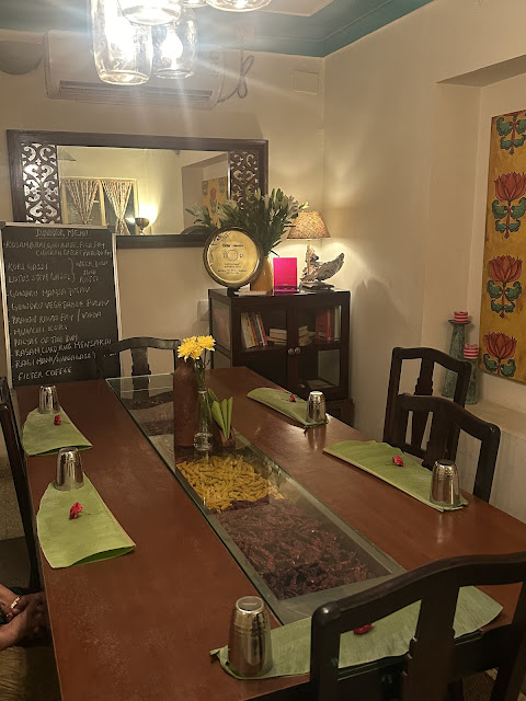 Tasting room ready for a meal at Bengaluru Oota Company with banana leaves for meals laid out